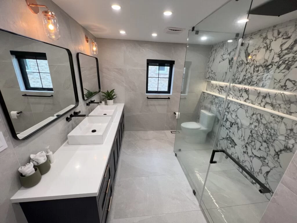Luxury bathroom renovation featuring double sinks and glass shower