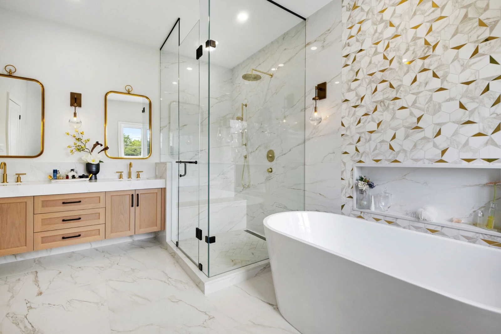 Modern bathroom renovation with wood vanity and gold fixtures
